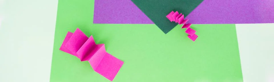 Banner with abstract background in green, pink and purple, paper zigzag pattern Stock Photos