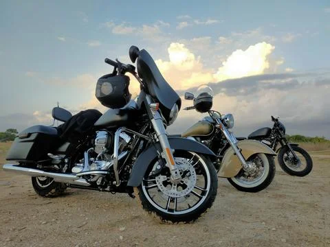 Banner advertisement single one three Motorbike on road at sunset against sunset Stock Photos
