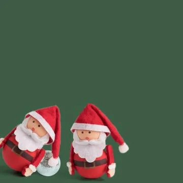Banner, backdrop or background with two cute Santa Claus Doll on a green back Stock Photos