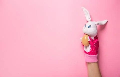 Banner with bunny and an Easter egg on pink background with copy space, empty Stock Photos