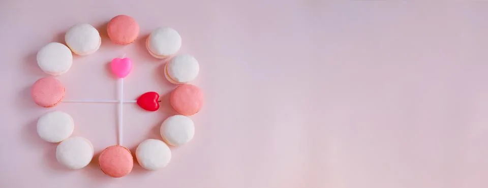 Banner Creative clock made of macaroons on a pink background Stock Photos