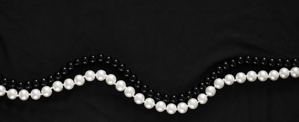 Banner in a dark key with two strings of pearl Stock Photos