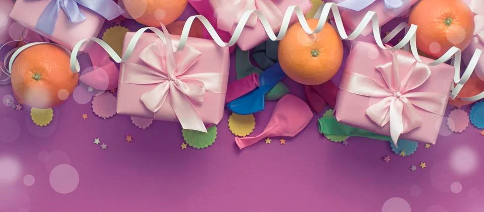 Banner Decorative composition Three boxes with gifts Satin ribbon Bow Oranges Stock Photos