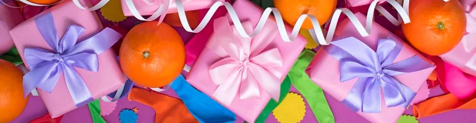Banner Decorative composition Three boxes with gifts Satin ribbon Bow Oranges Stock Photos