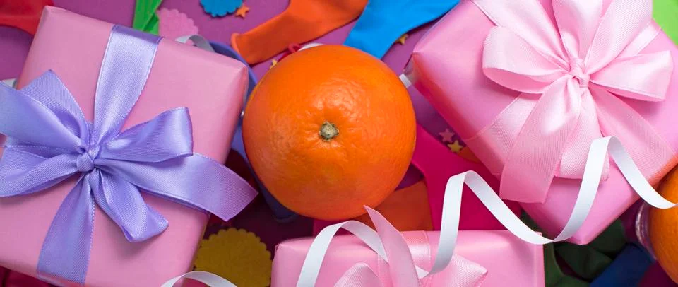Banner Decorative composition Three boxes with gifts Satin ribbon Bow Oranges Stock Photos