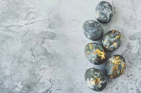 Banner. Easter eggs are gray and gold on a gray marble background. Minimal .. Stock Photos