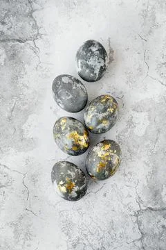 Banner. Easter eggs are gray and gold on a gray marble background. Minimal Stock Photos