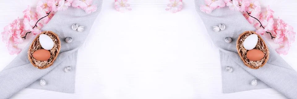 Banner from Easter eggs in the nest on textile napkin with sakura blossom. Stock Photos