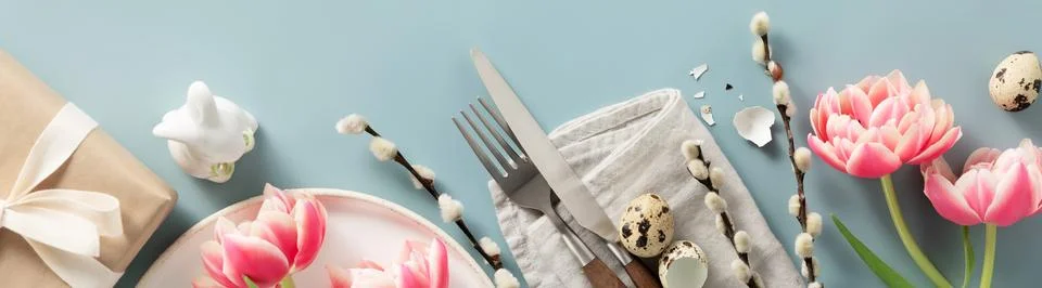 Banner. Easter table setting with white plate, spring flowers and cutlery. .. Stock Photos