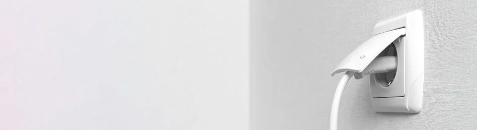 Banner with electrical plug in the electric socket on a wall, interior photo  Stock Photos