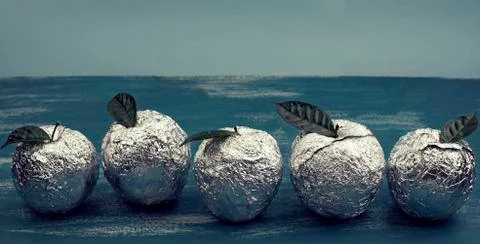 Banner Five apples in the shell foil with natural green leaves. Stock Photos