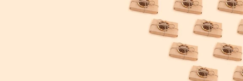 Banner with gift boxes pattern on a beige background. Stock Photos