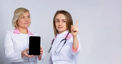 Banner- long format. Forefinger up. Doctors using digital tablet computer mock Stock Photos