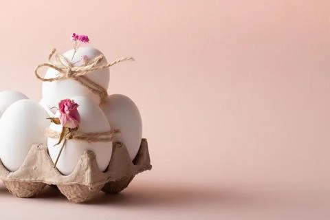 Banner postcard with Easter eggs and eco-decor of dried roses on a beige ba.. Stock Photos