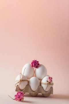 Banner postcard with Easter eggs and eco-decor of dried roses on a beige back Stock Photos