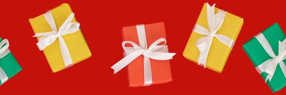 Banner of seamless holiday pattern. multi-colored gifts on a red background. Stock Photos