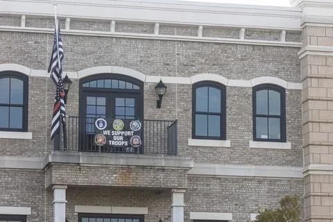 Banner supporting troops hangs from condo balcony Stock Photos