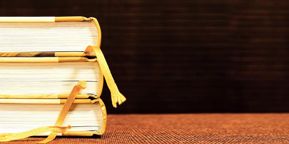 Banner template with hardcovered books stack with bookmarks on a shelf Stock Photos