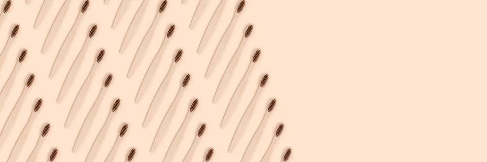 Banner with toothbrushes pattern on a beige background. Stock Photos
