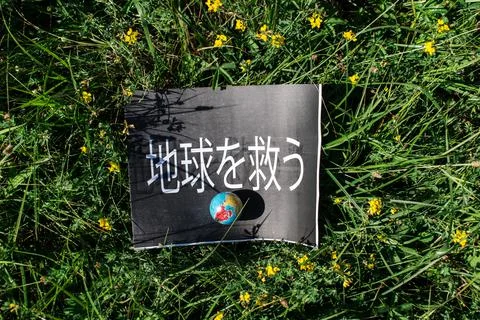 Banner on which is written the text "Save the Earth"- in Japanese language. Stock Photos