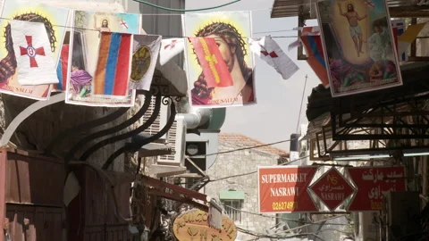 Banners with Jesus and flags hanging in Jerusalem Stock Footage 231477060