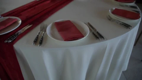Banquet round table. Serving on a white tablecloth with red napkins. Stock Footage 109143484