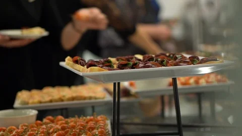 On the Banquet table are plates with various snacks, sandwiches, canapes Stock Footage 127104076
