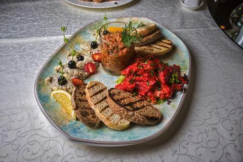 Banquet vegetable snacks and bread toasts on a plate, selective focus Stock Photos