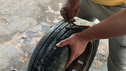 Bantul, Indonesia - 03/29/2024: the process of patching car tubeless tires Stock Footage 270882033