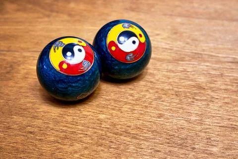 Baoding balls on a wooden surface Stock Photos