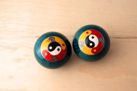 Baoding balls on a wooden surface Stock Photos