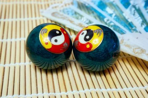 Baoding balls with yin-yang symbol and a fan Stock Photos