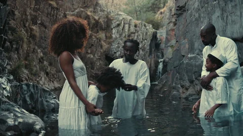 Baptism pool ceremony showcases deep faith in beautiful natural setting Stock Footage 319906021