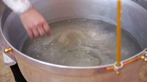 Baptism. The priest blesses the water in the font. Clouse up Stock Footage 68177953