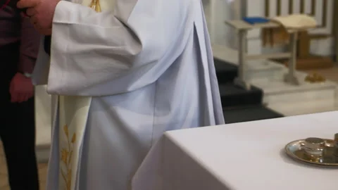 Baptism process in a catholic church. Priest follow shot Video stock 219901618