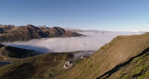 Baqueira, Spain with winding roads down mountain in summer drone aerial 4k Stock Footage 125759036