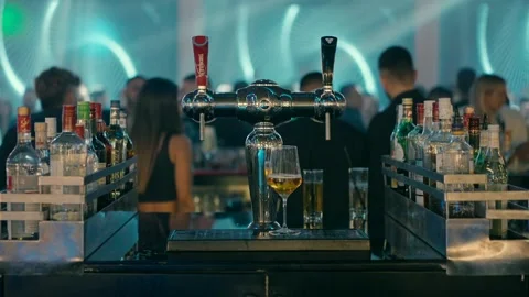 A bar with alcoholic drinks and a beer dispenser. Stock Footage 231138271