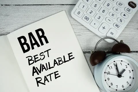 BAR Best Available Rate text on paper notebook page with alarm clock and ca.. Foto stock