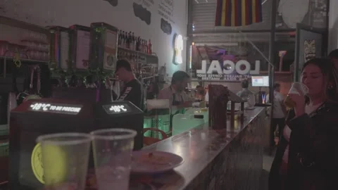 A bar in Buenos Aires, Argentina, with a bartender and customers Stock Footage 345143265