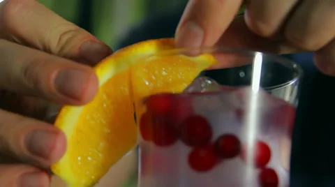Bar chef decorating cocktail with orange slice and mint Stock Footage 41777222