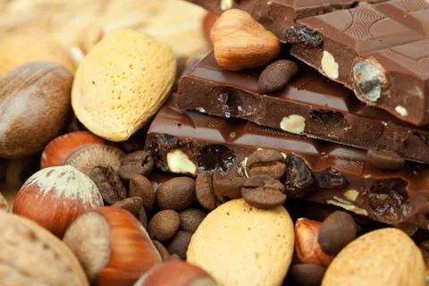 Bar of chocolate and nuts on a wicker mat Stock-Fotos