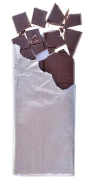 Bar of chocolate with broken cubes in silver foil packaging Stock Photos