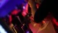 Bar in club. Visitors get their drinks, bartender lights visitor's cigarette HD Footage