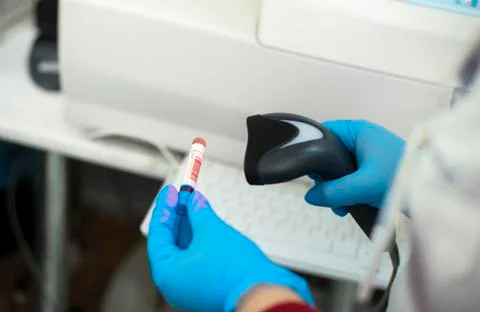 Bar code scanner and test tube over monitor of complete blood count analyzer  Stock Photos