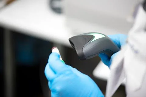 Bar code scanner and test tube over monitor of complete blood count analyzer  Stock Photos