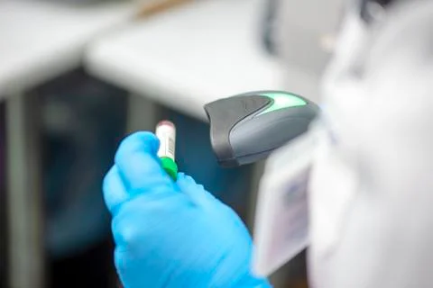 Bar code scanner and test tube over monitor of complete blood count analyzer  Stock Photos