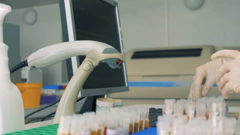 Bar codes of test tubes are getting scanned Stock Footage 93737284