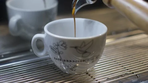 Bar coffee maker making espresso coffee falling into cup close up Video stock 148233231
