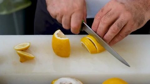 Bar counter cuts a yellow lemon Stock Footage 210608669