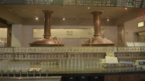 Bar Interior With Copper Brewing Tanks and Glassware in Beijing Brewery Setting Stock Footage 345757009